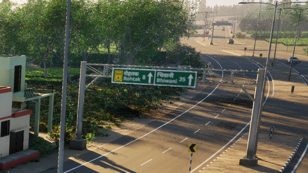 A green overhead NH 9 sign over a curving divided highway, reading Rohtak 8 and Bhiwani 35 in Hindi and English, in low evening sun